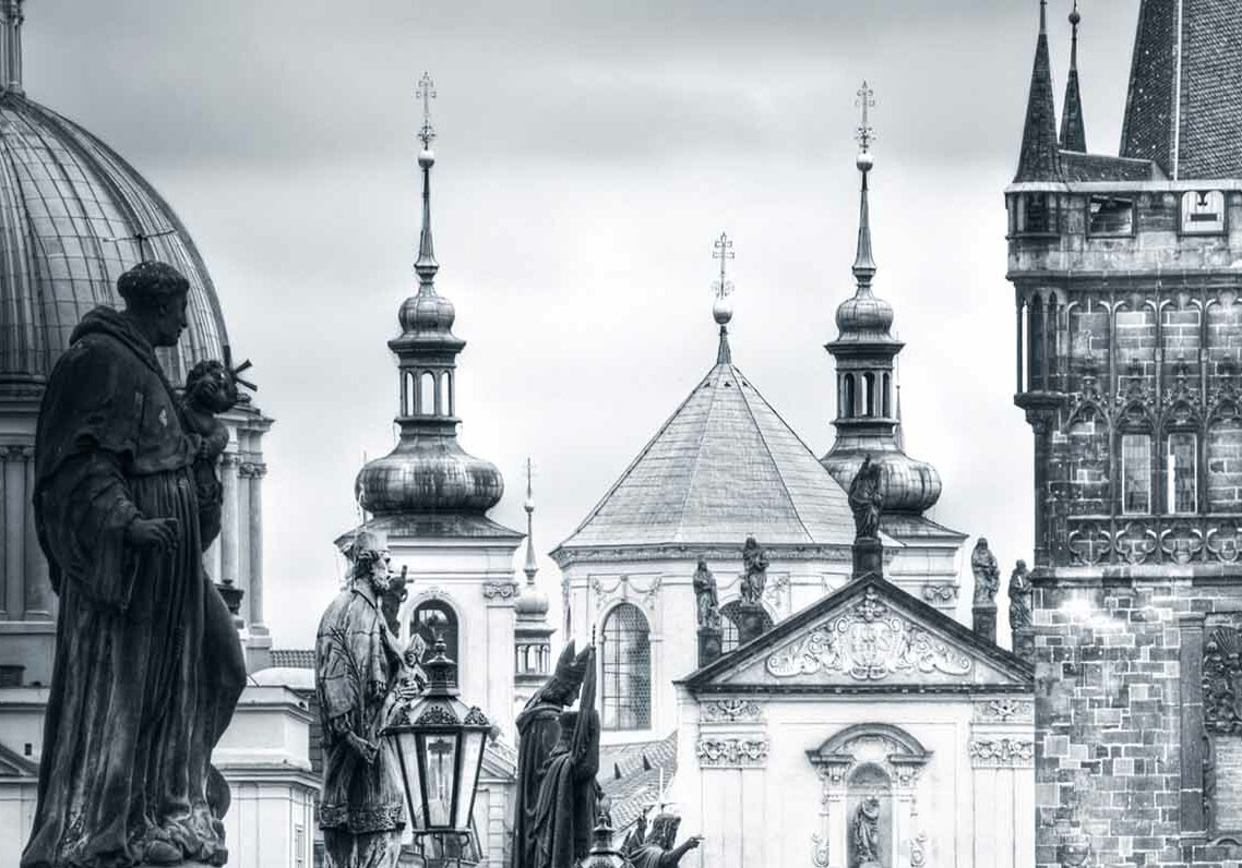 View of Charles Bridge and monuments in Prague, Europe. Black&amp;white picture.