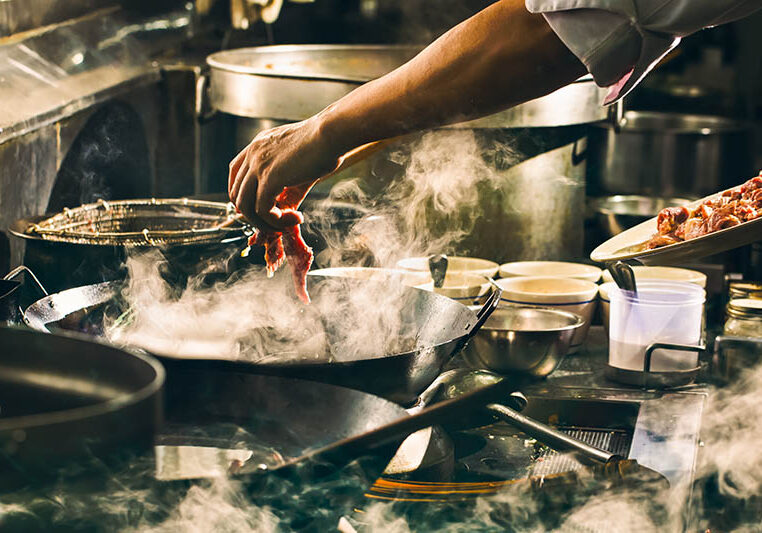 Chef is cooking beef in wok