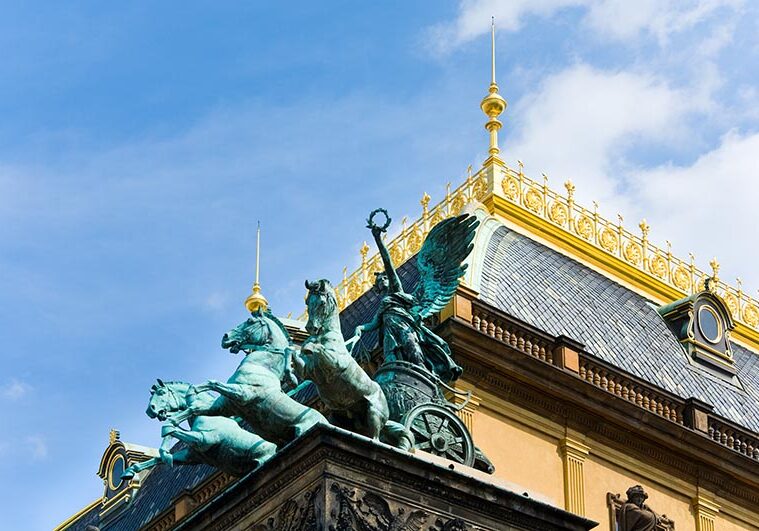 Bronze three horse chariot on top of Prague National Theater (reopened in 1883, Czech Republic)