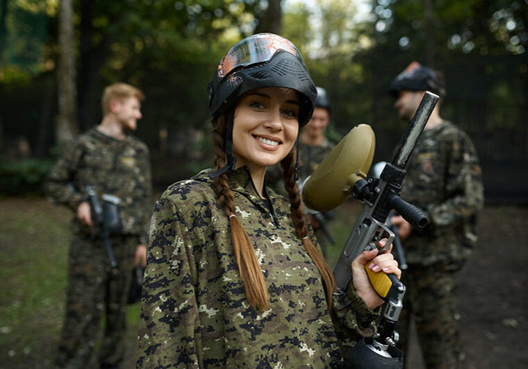 Soldiers in camouflage and masks playing paintball, war on playground in the forest. Extreme sport with pneumatic weapon and paint bullets or markers, military team game outdoors, combat tactics