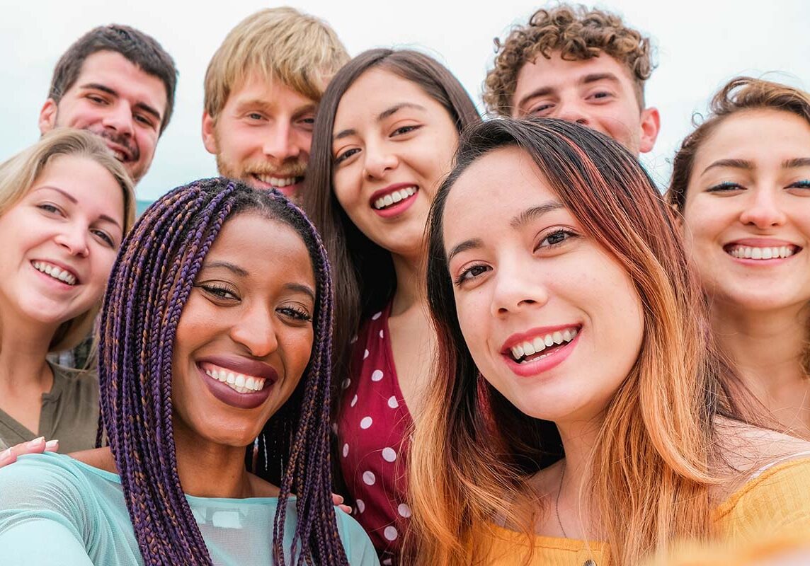 Young friends from diverse cultures and races taking photo making happy faces - Youth, millennial generation and friendship concept with students people having fun together - Focus on close-up girls